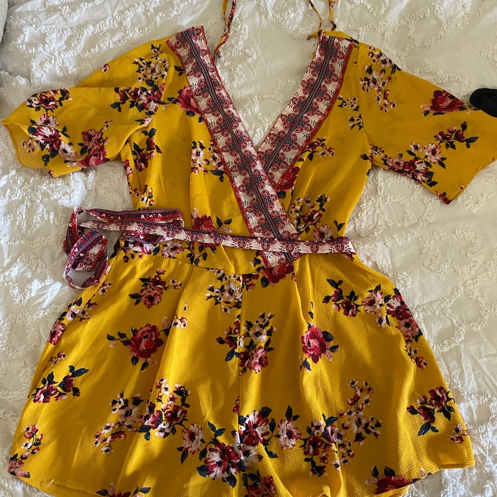 Yellow romper with red and white accents. Size S